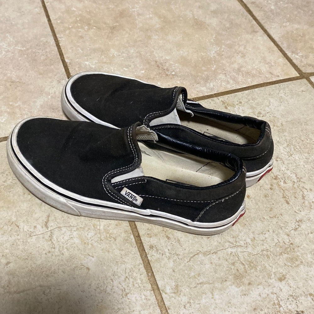 Black and white slip-on Vans